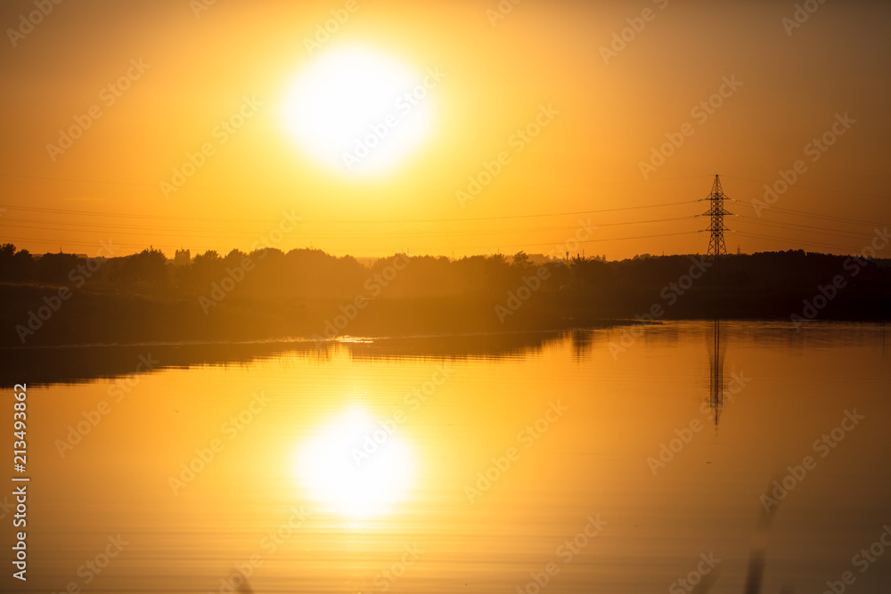 Sunset with a reflection in the water of a lake in nature