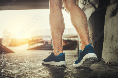 Close up of male feet in motion. Muscular guy is training in snickers to stay fit