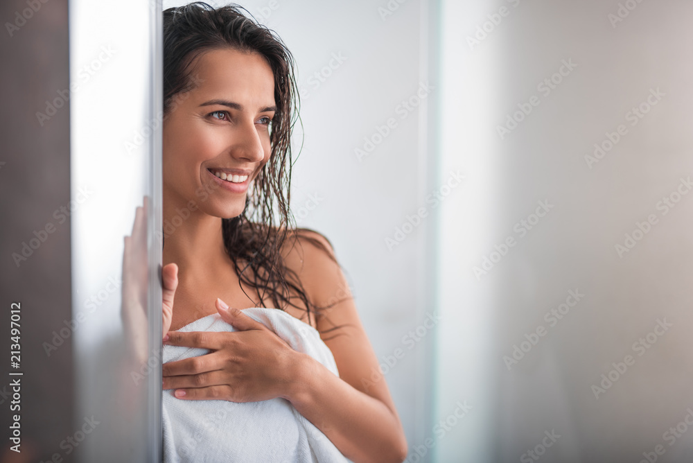 Portrait of satisfied woman with wet hair situating indoor after bath Portrait of satisfied woman with wet hair situating indoor after bath