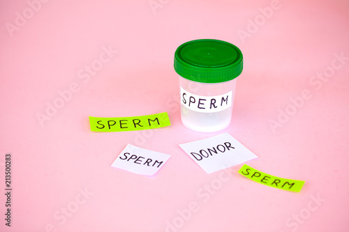 Health. Close up Sperm Analysis. Concept of Bank Sperm. Infertility Bank with Sperm on Pink Background with Towel photo