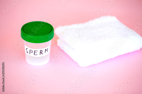 Health. Close up Sperm Analysis. Concept of Bank Sperm. Infertility Bank with Sperm on Pink Background with Towel photo