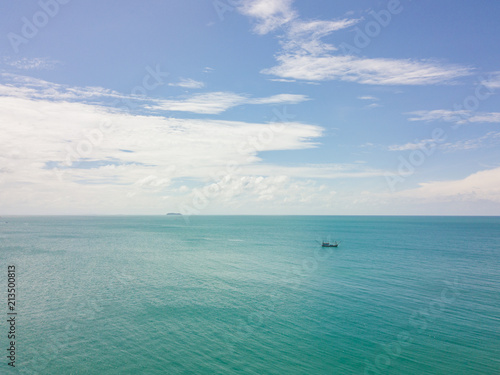 Small boats fishing in the blue ocean photo