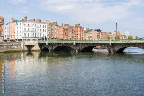 Buildings, bridge and boat in Leffey river