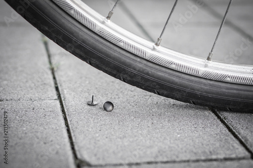 Bike driving over a pin