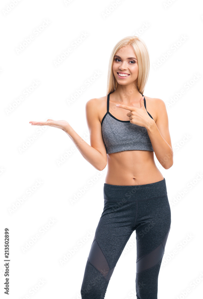Woman in fitnesswear showing or giving something, over white Woman in fitnesswear showing or giving something, over white