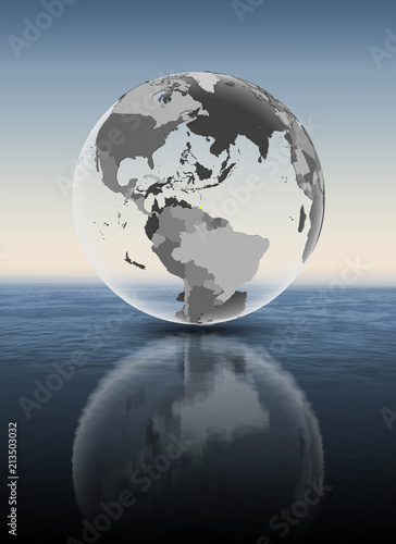 Caribbean on translucent globe above water