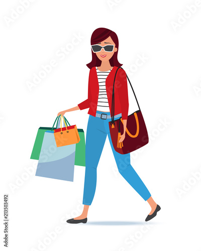 Beautiful fashionable girl shopper in glasses, purchases made in shops. photo