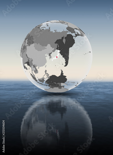 Japan on translucent globe above water