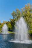 Two large hitting fountains in the middle of a clear blue decorative lake