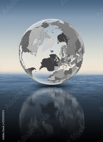 Iceland on translucent globe above water