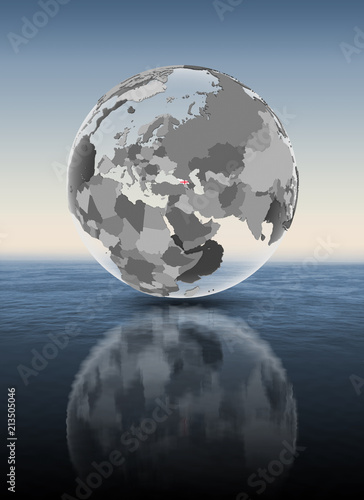 Georgia on translucent globe above water