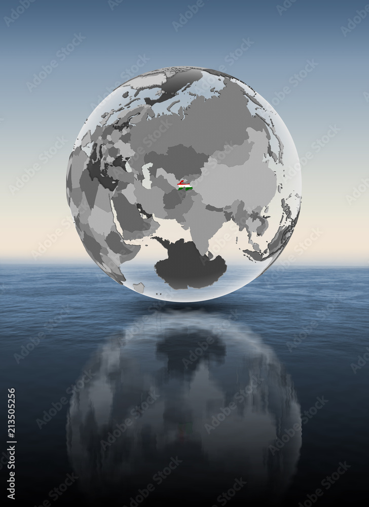 Tajikistan on translucent globe above water Tajikistan on translucent globe above water