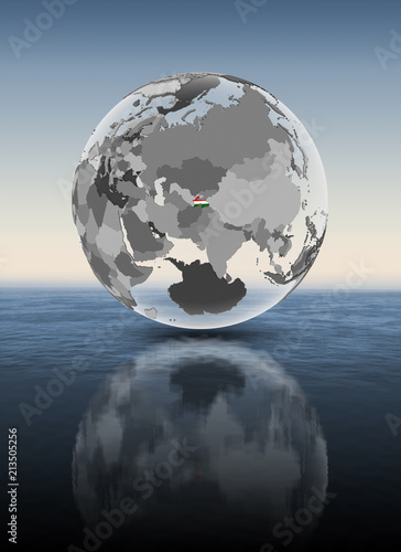 Tajikistan on translucent globe above water