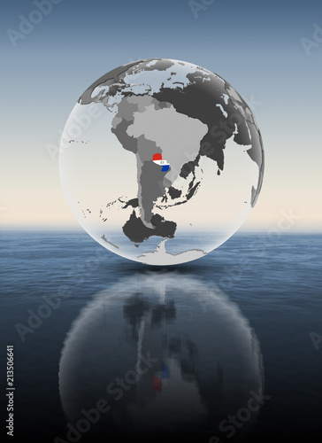 Fototapeta Naklejka Na Ścianę i Meble -  Paraguay on translucent globe above water