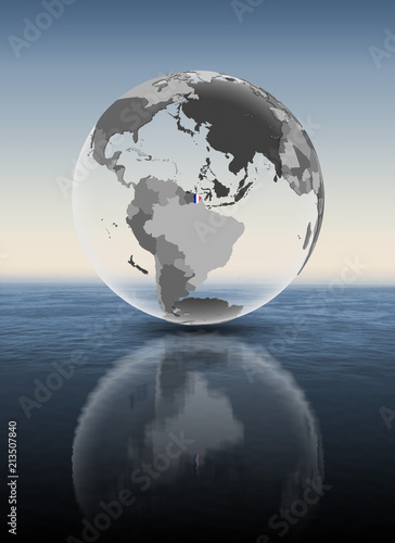 French Guiana on translucent globe above water