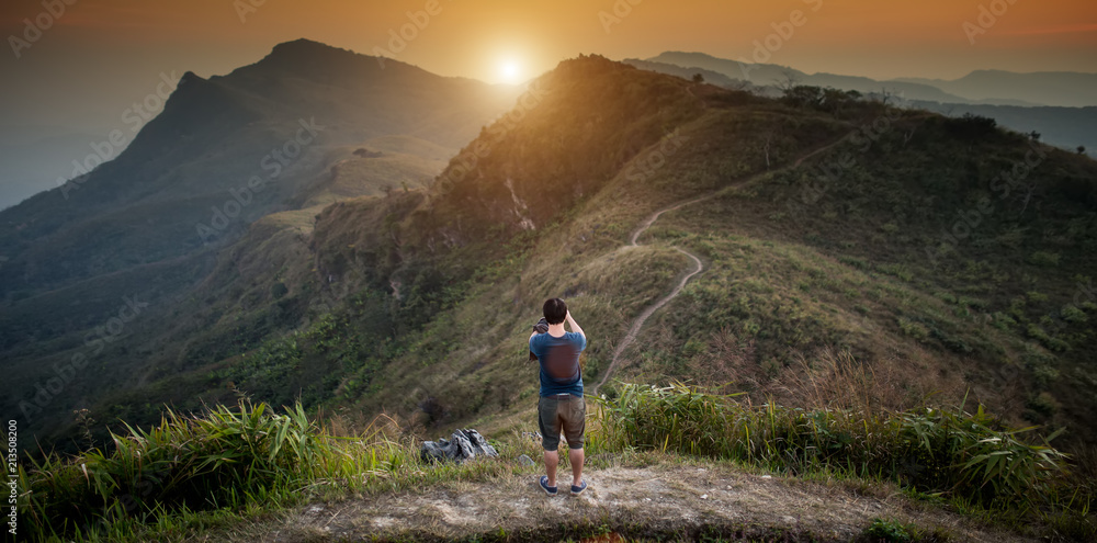 man stands on top mountain