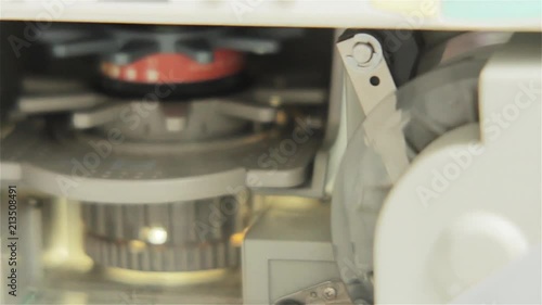 Male Hand Maneuvering a Microfilm Reader. Close-Up. 
