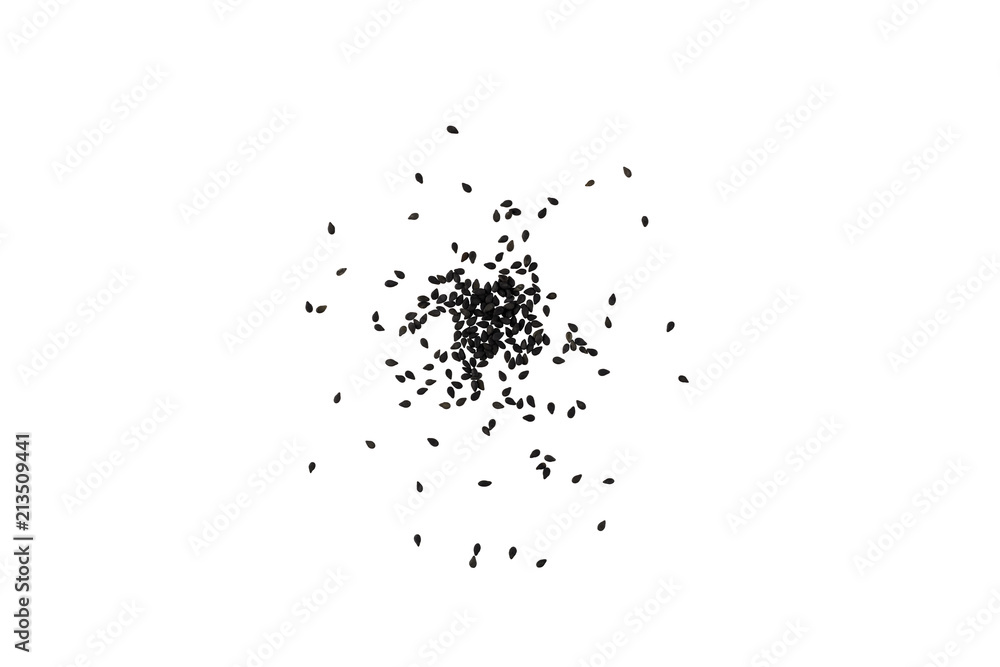 A scattering of black sesame seeds on a white background. A scattering of black sesame seeds on a white background.