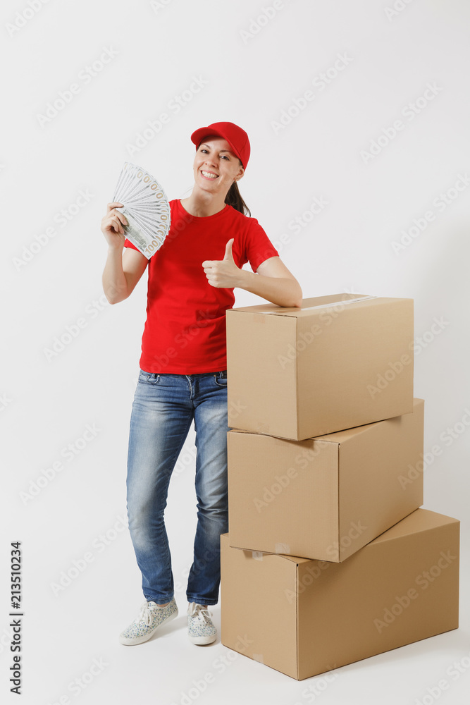 Full length of delivery woman in red cap, t-shirt isolated on white background. Female courier near empty cardboard boxes, bundle of dollars, cash money. Receiving package. Copy space advertisement. Full length of delivery woman in red cap, t-shirt isolated on white background. Female courier near empty cardboard boxes, bundle of dollars, cash money. Receiving package. Copy space advertisement.