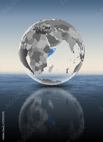 Somalia on translucent globe above water