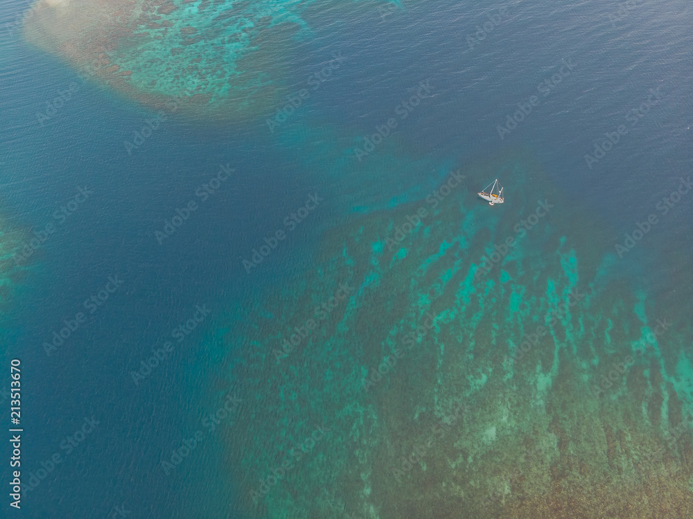 Boat and Dinghy On Caribbean Coral Reef