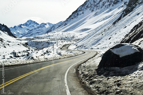 Street in between mountains and snow