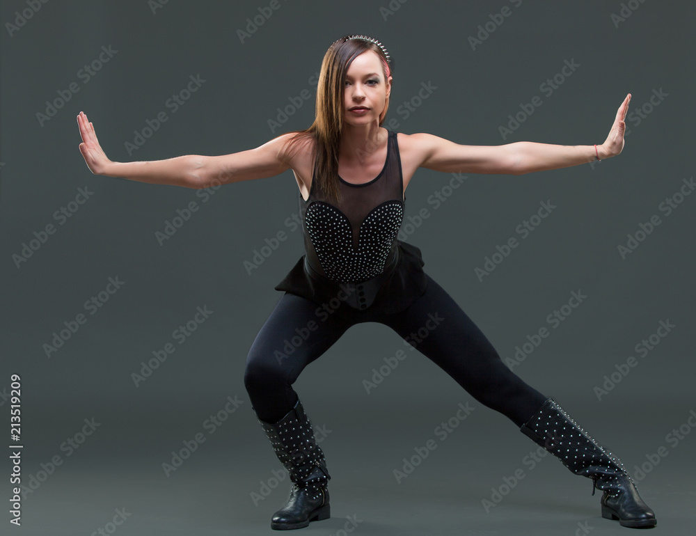 Obraz premium attractive young woman dancing, on a black background