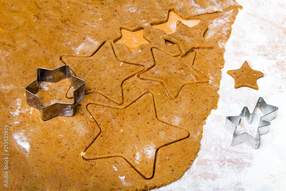 Preparing Christmas gingerbread cookies. Gingerbread dough and star shape cookies ingredients.