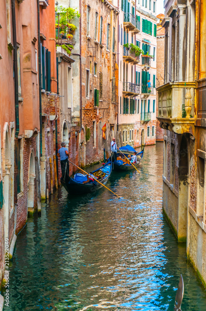 Gondoliers Calmly Propelling Along Canal in Venice, Italy