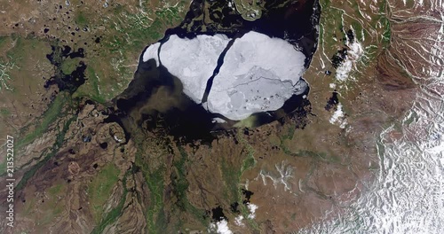 Very high-altitude overflight aerial of ice on Krasnoye Lake, northeastern Siberia. Clip loops and is reversible. Elements of this image furnished by USGS/NASA Landsat photo