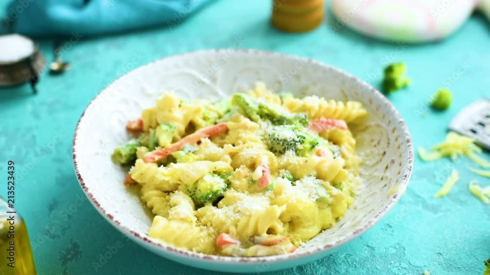 Baked cheesy pasta with vegetables on the table Baked cheesy pasta with vegetables on the table