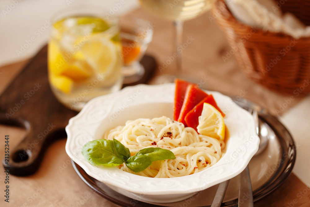Lunch meal pasta with cream sauce, served with glass of white wine Lunch meal pasta with cream sauce, served with glass of white wine