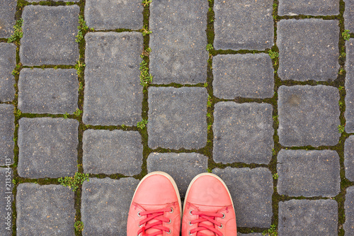 On the paving stones are red sneakers