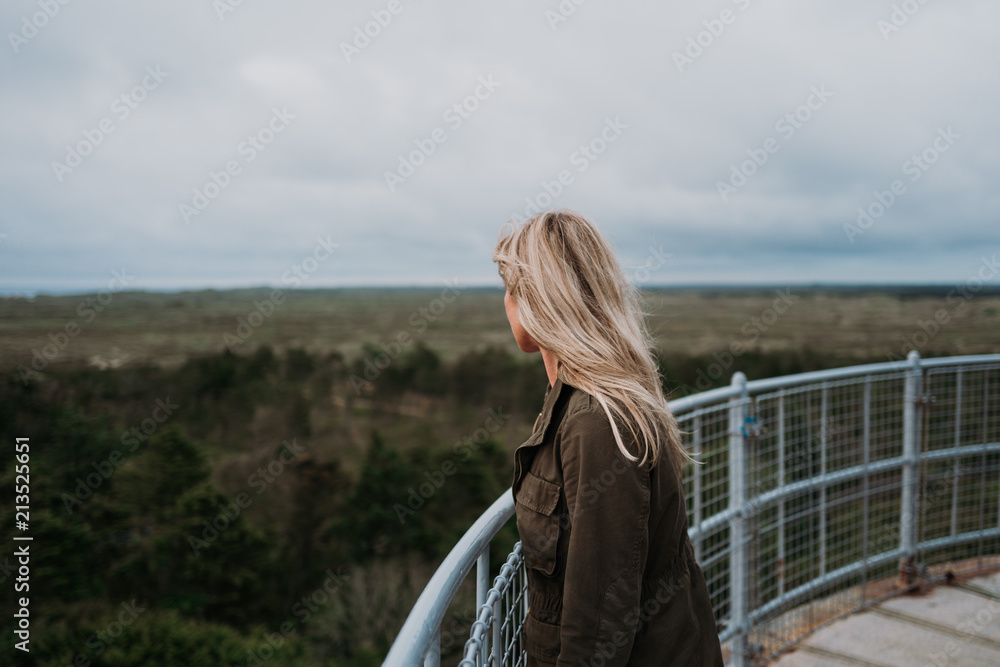 Woman enjoying the view from Lodbjerg Fyr, Denmark Woman enjoying the view from Lodbjerg Fyr, Denmark