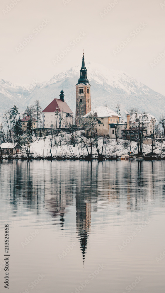 Lake Bled church covered in snow
