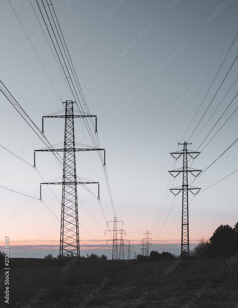 Power towers in a landscape at sunrise