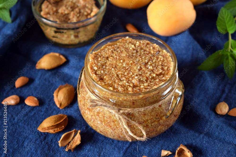 Urbech of apricot kernel in a glass jar. National Dagestani paste of