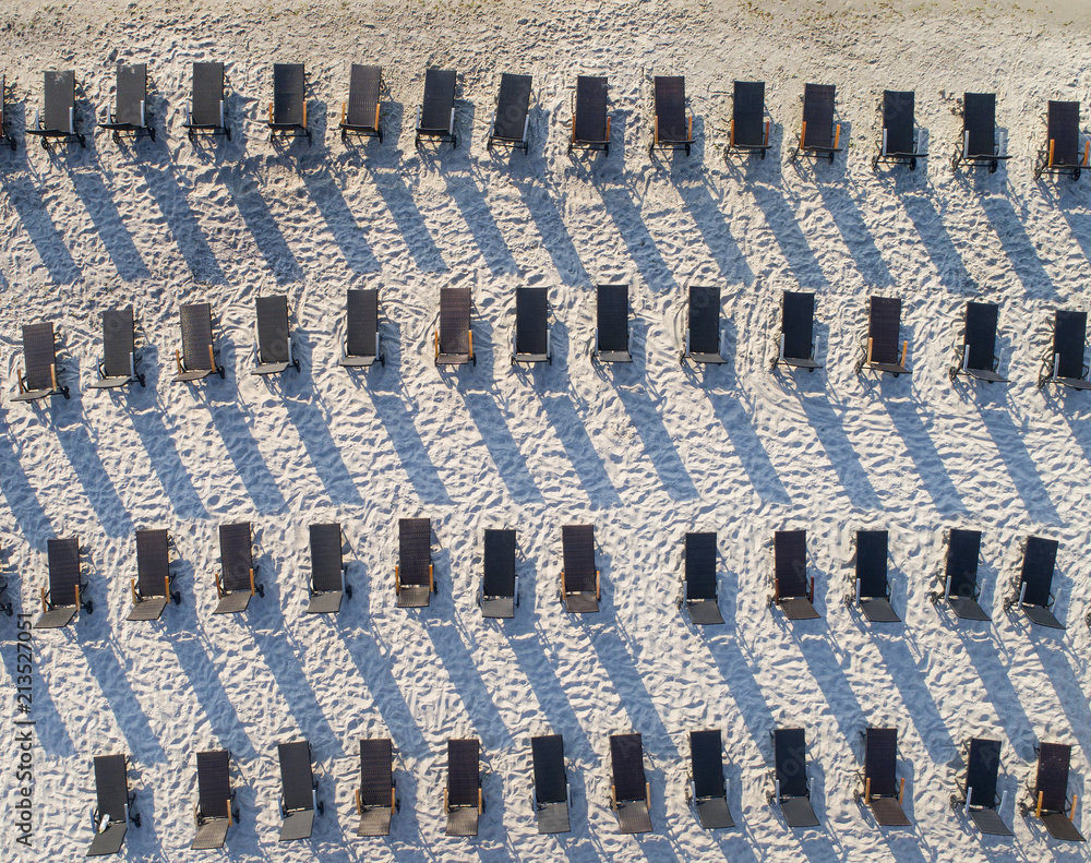 Fototapeta premium abstract view to sun chairs on the sand beach
