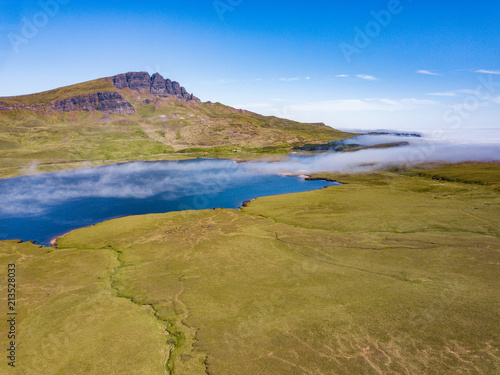 A low level mist rolls over a loch on The Isle Of Skye