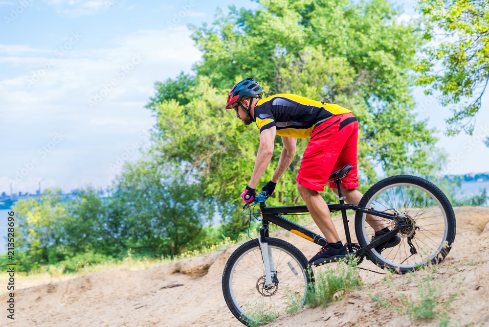 Professional cyclist descending from the top on a mountain bike, an extreme sport.