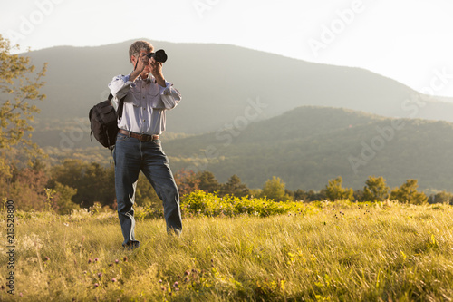 Mature Caucasian Man focusing Camera