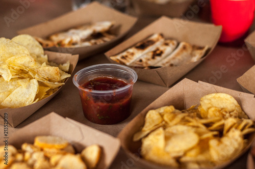 Snacks in paper eco-friendly boxes. Takeout food in a paper box. Fast food on the street