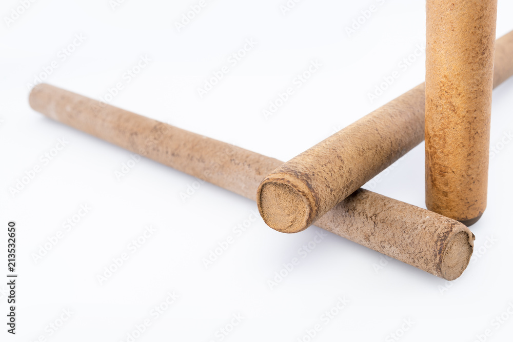 Ebonite sticks on white background. Also is known as hard rubber or vulcanite Ebonite sticks on white background. Also is known as hard rubber or vulcanite