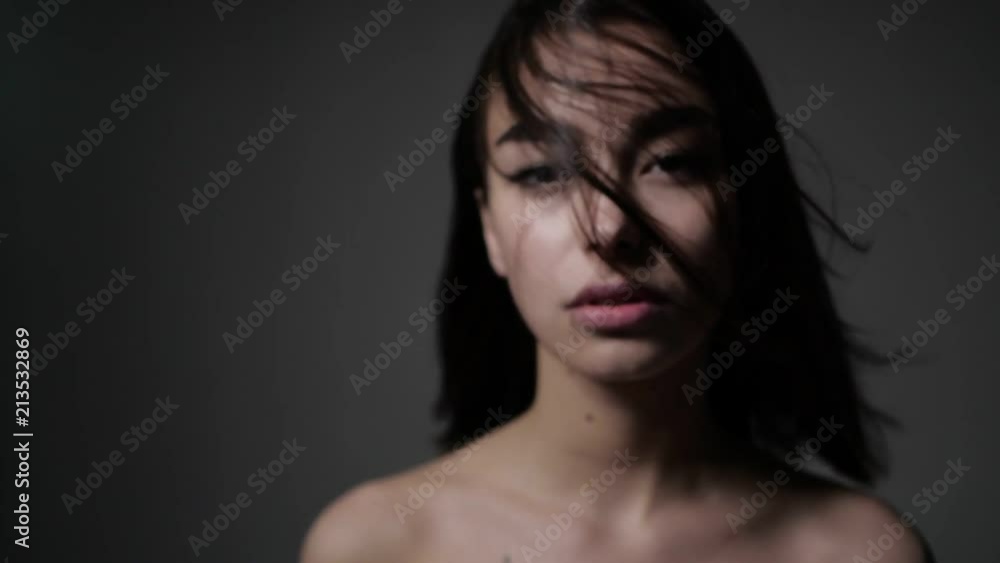 Girl is standing with face covered with hair Girl is standing with face covered with hair