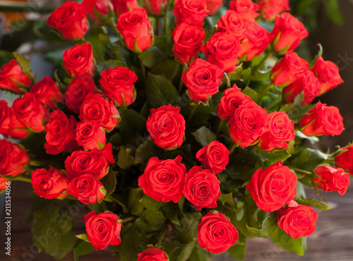 Coral roses on a old wooden table. Birthday gift with copy space. Romantic date.