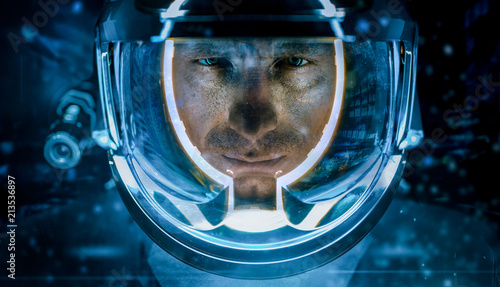 Man in glowing spacesuit helmet