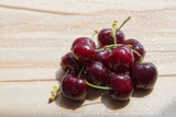 Pile of ripe cherry on wooden background with copy space