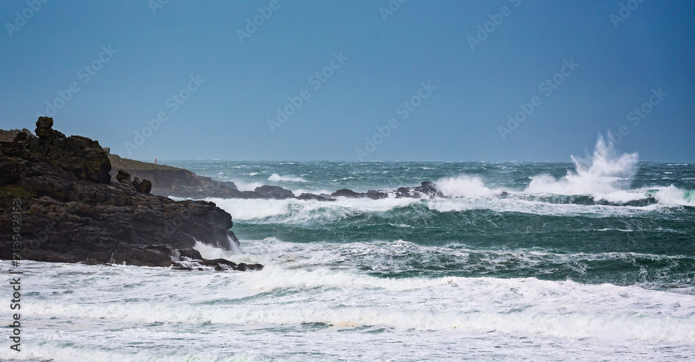 Dramatic stormy sea with large waves crashing onto rocks Dramatic stormy sea with large waves crashing onto rocks