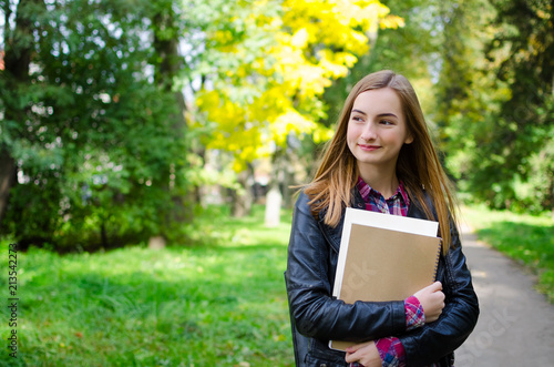 Teen girl outdoor holding books