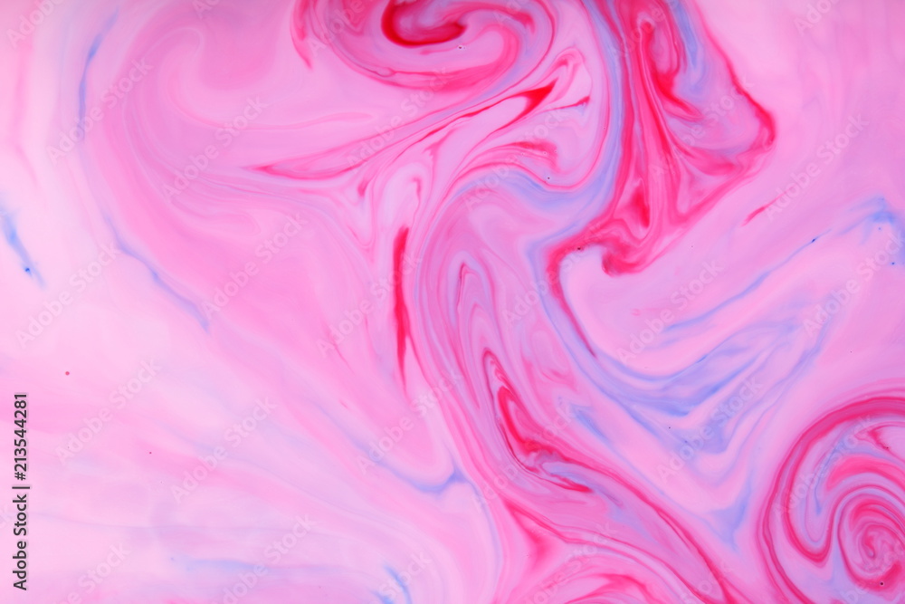 Pink blue abstract background, pink stains on the liquid, multi-colored pattern, food colors in the milk, color texture on the water, preparation for the designer